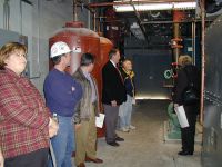 School Board members and administrators tour a mechanical room at S.G. Reinertsen Elementary School.