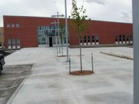 The main entrance sports colorful glass windows. Trees have been planted and lights are installed on the side of the school facing 14th Street.