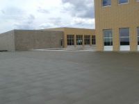 Concrete areas for playground space have been poured near the cafeteria.