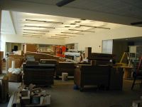 New light fixtures are installed in the cafeteria area of the school, and work continues on finishing the kitchen.