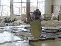 Workers lay the floor surface for the new commons / cafeteria space.