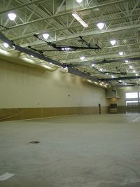 The curtain system attached to the ceiling allows the fieldhouse to be sectioned off into several areas. A track will circle the perimeter of the fieldhouse with basketball courts in the center area.