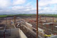 From the three-story academic wing, the foundation and structural steel for the media center, cafetorium, and gymnasium can be seen.