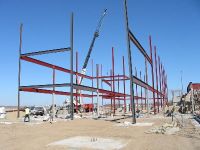 By mid April 2003, the structural steel is being erected for the three-story academic wing of the new middle school.