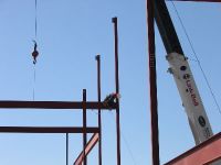 A construction worker secures the structural steel.